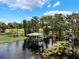 Ariel shot of a covered boat dock on the lake under sunny skies at 12130 Lakeshore Dr, Clermont, FL 34711