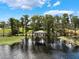 Scenic view of the covered boat dock in tranquil lake setting at 12130 Lakeshore Dr, Clermont, FL 34711