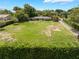 Expansive lawn with mature trees surrounds this charming single-story home at 12130 Lakeshore Dr, Clermont, FL 34711