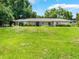 Charming single-story home with a large front yard and mature trees at 12130 Lakeshore Dr, Clermont, FL 34711