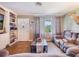 Comfortable living area with classic flooring, and a large window at 12130 Lakeshore Dr, Clermont, FL 34711