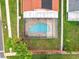 Bird's-eye view of the pool area, highlighting the brick-paved deck, screen enclosure, and grassy backyard at 12300 Abberton Ct, Orlando, FL 32837