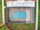 Aerial view of the pool highlighting the screened enclosure, brick-paved deck, and well-maintained backyard at 12300 Abberton Ct, Orlando, FL 32837