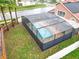 Overhead shot of the screened-in pool featuring brick pavers and clear pool steps, all in a private backyard at 12300 Abberton Ct, Orlando, FL 32837