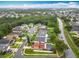 Aerial view showing a home with an enclosed pool and a serene community nestled among mature trees at 12300 Abberton Ct, Orlando, FL 32837