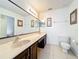 Bright bathroom featuring double sink vanity and large mirror at 12300 Abberton Ct, Orlando, FL 32837
