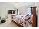 Comfortable bedroom featuring natural light, a floral bedspread, and a ceiling fan at 12300 Abberton Ct, Orlando, FL 32837