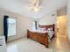 Bedroom with a wood bed frame, tile flooring, ceiling fan, and natural light from windows at 12300 Abberton Ct, Orlando, FL 32837