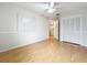 Bedroom with wood flooring, ceiling fan, and large closet; entrance to bathroom visible at 12300 Abberton Ct, Orlando, FL 32837