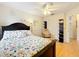 Bedroom with floral bedding, ceiling fan, chair, and closet, featuring a decorative quote and natural light at 12300 Abberton Ct, Orlando, FL 32837