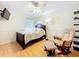Comfortable bedroom with ceiling fan, accent wall, and sleek flooring at 12300 Abberton Ct, Orlando, FL 32837