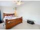 Bedroom with a stylish bed frame, decorative table, and bright neutral walls at 12300 Abberton Ct, Orlando, FL 32837