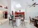 Open kitchen features a breakfast bar, stainless steel appliances, and ample cabinet space at 12300 Abberton Ct, Orlando, FL 32837