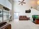 Large living room showcasing natural light, a leather sofa, and modern design elements at 12300 Abberton Ct, Orlando, FL 32837