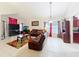 Spacious living room featuring tile floors, leather sofas, an aquarium, and decorative details at 12300 Abberton Ct, Orlando, FL 32837