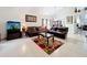 Inviting living room with vaulted ceilings, tile floors, leather furniture, and aquarium at 12300 Abberton Ct, Orlando, FL 32837