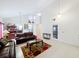 Bright living room with vaulted ceilings, tile flooring, leather seating, and ample natural light at 12300 Abberton Ct, Orlando, FL 32837