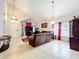 Open-concept living room featuring tile floors, vaulted ceilings, leather couches, and a television at 12300 Abberton Ct, Orlando, FL 32837