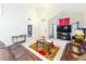 Open living room featuring tile floors, vaulted ceilings, leather couches, and a television at 12300 Abberton Ct, Orlando, FL 32837