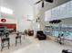 Inviting living room featuring a kitchen island, bright lighting, and views of the pool at 12300 Abberton Ct, Orlando, FL 32837