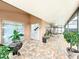 Covered outdoor patio featuring brick flooring, patio furniture, potted plants, and view of the pool at 12300 Abberton Ct, Orlando, FL 32837