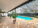 Backyard with screened-in patio, brick pavers, and sparkling pool at 12300 Abberton Ct, Orlando, FL 32837