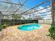 Inviting screened pool area with brick pavers, mature plantings, and a relaxing atmosphere for serene outdoor living at 12300 Abberton Ct, Orlando, FL 32837