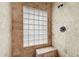 Tiled shower with glass block window and built-in bench at 12300 Abberton Ct, Orlando, FL 32837