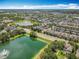 Stunning aerial view showcasing community homes, sparkling lakes, and lush green landscapes at 13055 Overstreet Rd, Windermere, FL 34786
