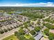Sprawling aerial view of homes nestled amidst lush green trees and a serene lake at 13055 Overstreet Rd, Windermere, FL 34786