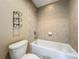 Bathroom featuring a tiled shower/tub combination and a modern toilet with towel rack at 13055 Overstreet Rd, Windermere, FL 34786