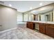 Elegant primary bathroom featuring a soaking tub, dual vanities, and tile flooring at 13055 Overstreet Rd, Windermere, FL 34786