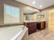 Bright bathroom features a soaking tub, double vanity, and a large mirror at 13055 Overstreet Rd, Windermere, FL 34786