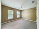 Bedroom with two windows and ceiling fan at 13055 Overstreet Rd, Windermere, FL 34786