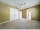 Carpeted bedroom with neutral decor and double doors at 13055 Overstreet Rd, Windermere, FL 34786