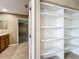 Built-in closet shelving offering ample storage space located next to the bathroom at 13055 Overstreet Rd, Windermere, FL 34786