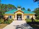 Exterior of community amenity building with a green roof and columns at 13055 Overstreet Rd, Windermere, FL 34786