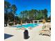 Community pool with lounge chairs, sun umbrellas and pergola at 13055 Overstreet Rd, Windermere, FL 34786