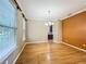 Bright dining room featuring hardwood floors, crown molding, and large windows at 13055 Overstreet Rd, Windermere, FL 34786