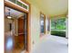 Inviting entryway with an open door, showcasing wood floors and light-filled spaces at 13055 Overstreet Rd, Windermere, FL 34786