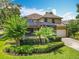 Professionally landscaped exterior featuring screened pool, oversized driveway and a two car garage at 13055 Overstreet Rd, Windermere, FL 34786