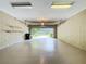 Spacious garage with concrete block walls, epoxy flooring, and an open view of the driveway at 13055 Overstreet Rd, Windermere, FL 34786