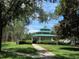 Picturesque gazebo with green roof and surrounding greenery and sidewalk at 13055 Overstreet Rd, Windermere, FL 34786