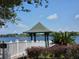 Picturesque gazebo overlooking a serene lake, surrounded by lush landscaping at 13055 Overstreet Rd, Windermere, FL 34786