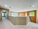 Upstairs hallway with neutral carpeting, architectural details, and windows providing natural light at 13055 Overstreet Rd, Windermere, FL 34786