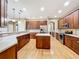 Spacious kitchen features wood cabinets, stainless steel appliances, light countertops, and center island at 13055 Overstreet Rd, Windermere, FL 34786
