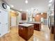 Open concept kitchen with a large island, wooden cabinetry, and modern appliances at 13055 Overstreet Rd, Windermere, FL 34786