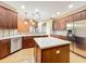 Open kitchen features wood cabinets, stainless steel appliances, light countertops, and tiled backsplash at 13055 Overstreet Rd, Windermere, FL 34786