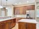 Spacious kitchen features wood cabinets, stainless steel appliances, light countertops, and center island at 13055 Overstreet Rd, Windermere, FL 34786