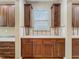 Kitchen featuring rich cabinetry, mosaic backsplash, and a functional layout at 13055 Overstreet Rd, Windermere, FL 34786